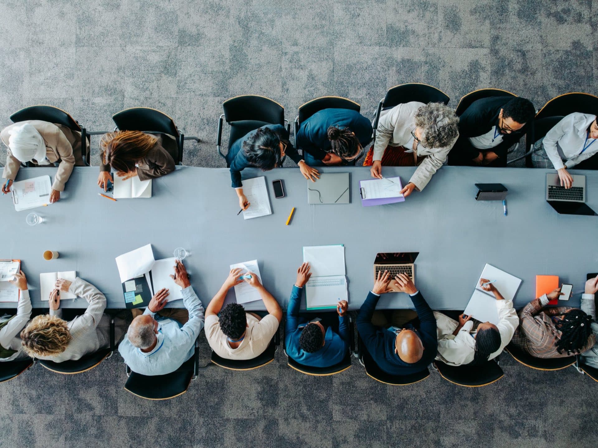 Colleagues collaborating around a large meeting table